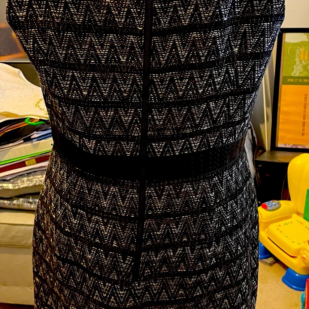 Multi color dress with leather accents at the collar and waist.